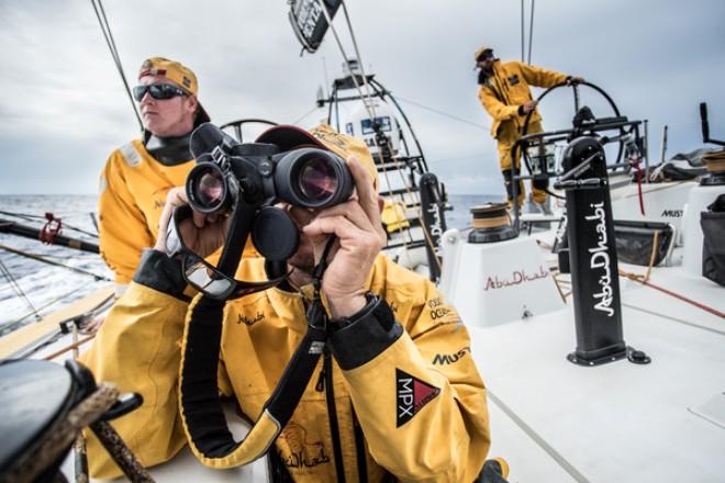Abu Dhabi Ocean Racing - Phil Harmer takes the bearing on Dongfeng and checks their sail combination to match speed as Alex Higby and Ian Walker look on - Volvo Ocean Race 2014-15 © Matt Knighton/Abu Dhabi Ocean Racing